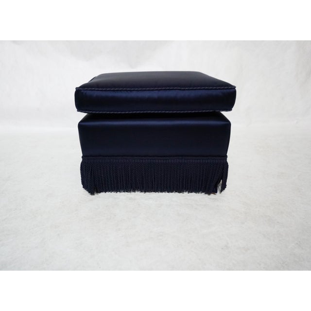 Blue Ottoman With Fringed Skirt Beautifully upholstered in a striking blue satin material with braid piping in a matching...