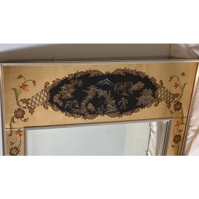 An Elegant hand painted eglomise framed beveled wall mirror. The artist signed frame and dated 1978 with a chinoiserie...