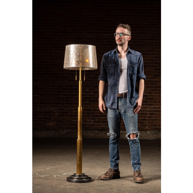 Vintage modernist brass floor lamp. This striking floor lamp features a tiered brass column base and dual pull-chain...