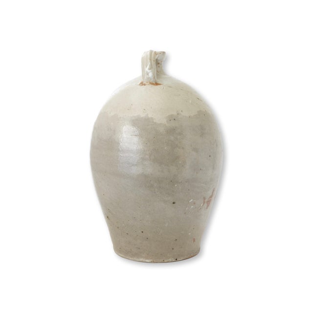 Late 19th century French glazed terracotta jug with a generous rounded form and traditional single handle at the neck. The...