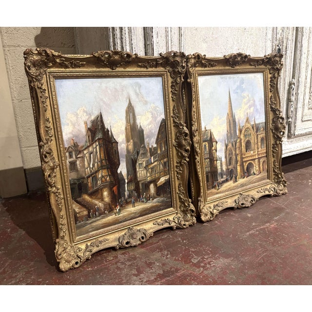 Rich in architectural detail and Old World atmosphere, this pair of antique Continental townscape paintings is by British...