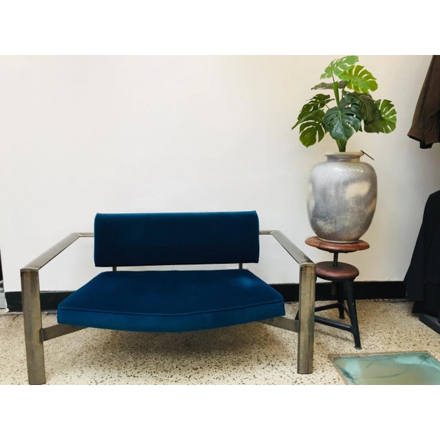 The backrest reclines and the upholstery is dark blue velvet.