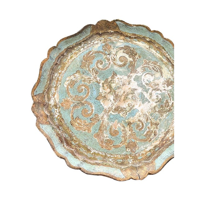 This petite Florentine side table is painted turquoise and gold. It has a sturdy pedestal base.