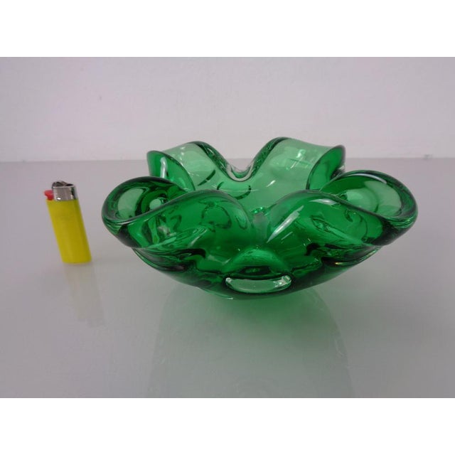 Murano glass bowl or ashtray from the 1960s, made of green glass. I have official proof of authenticity such as vintage...