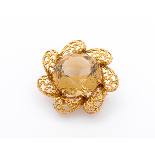 14K Yellow Gold Smoky Quartz Brooch, designed as a floral frame with one centered prong set round brilliant cut smoky...