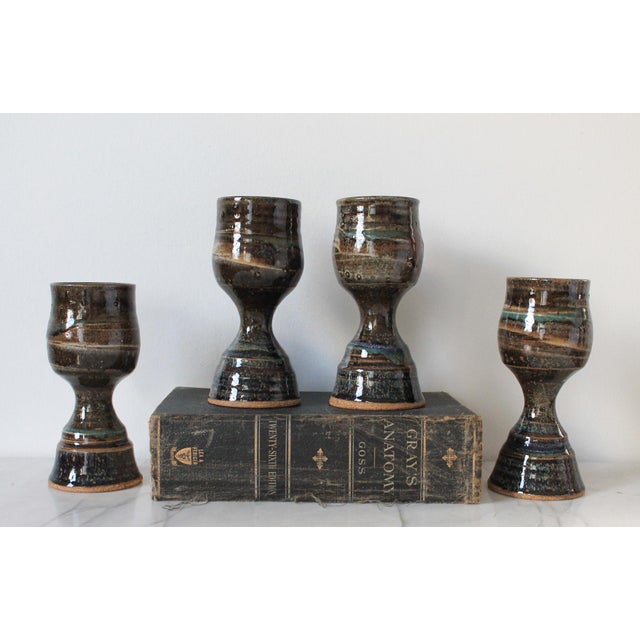 Set of four vintage studio pottery goblets. Could also serve as candle holders if you flip them upside down. No makers...