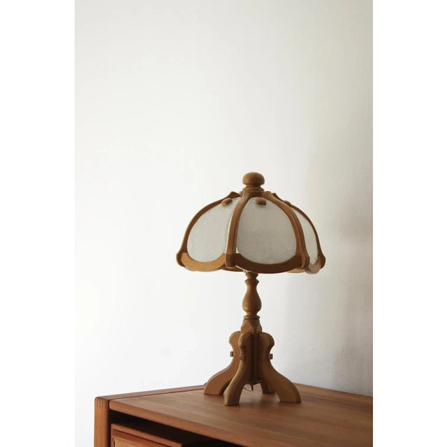 A unique table lamp from the German brand Asmuth Leuchten, combining natural wood with delicate glass—a harmonious duo of...