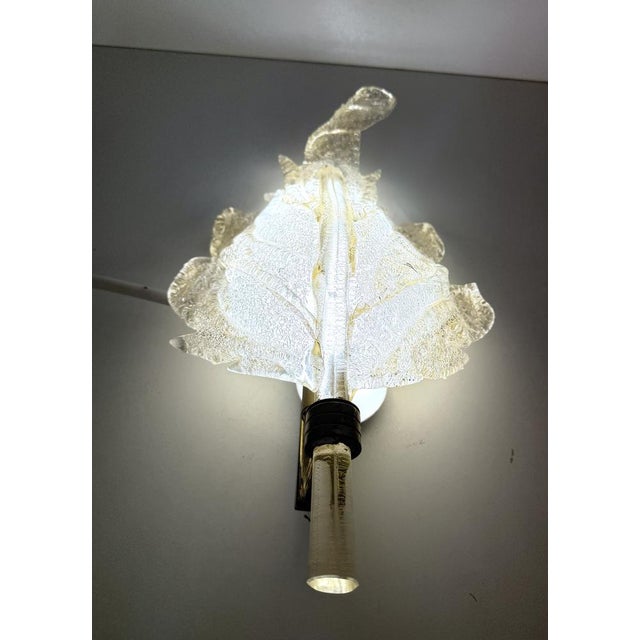 xItaly, 1940s- 1950s. This large applique is made in hand-modeled Murano glass with gold leaf and a brass frame. This wall...