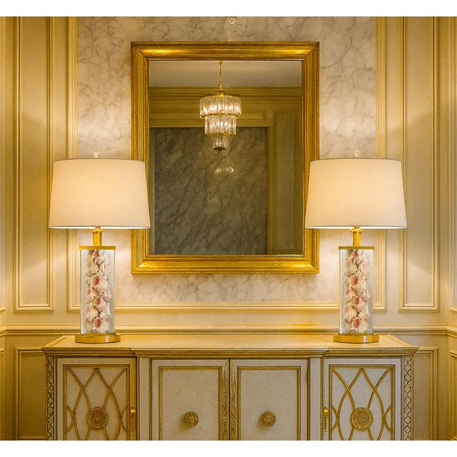 Offering a unique rare pair of Ralph Lauren glass table lamps filled with pink murex seashells, circa Late 20th Century....