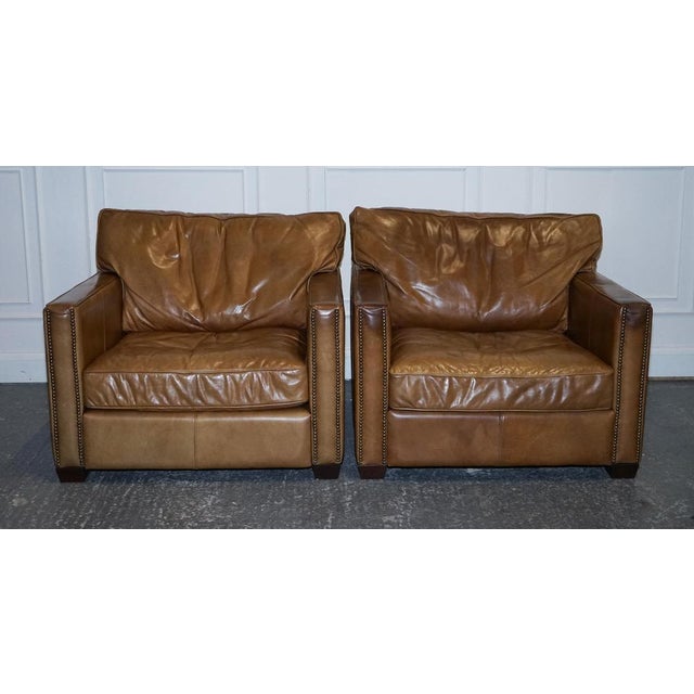 Timothy Oulton Viscount Pair of Tan leather Armchairs. A lovely pair, timeless and top notch quality armchairs. There are...