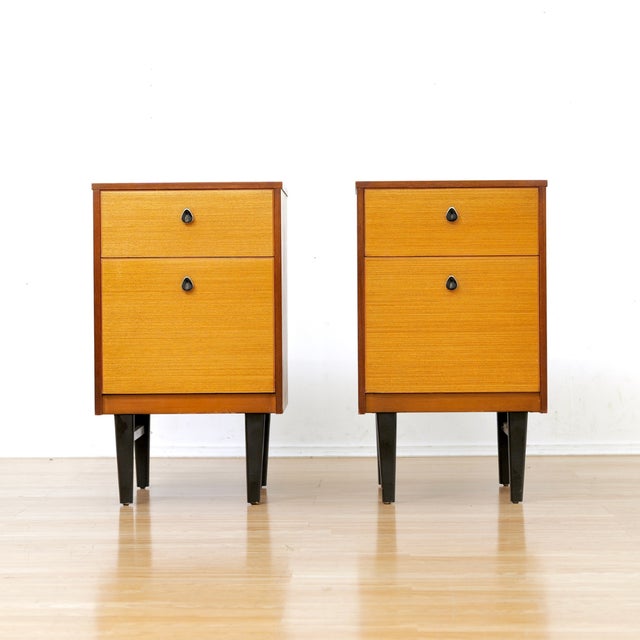 Pair of mid century nightstands made produced in England during the 1960s. Made of Mahogany and maple, they consist of a...