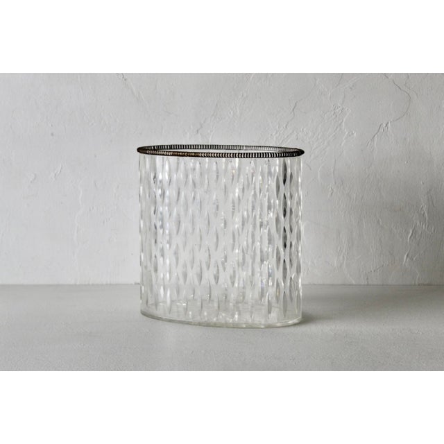 A vintage MCM Oval decorative wastebasket featuring a textured faceted pattern and a silver/brass dark beaded rim along...