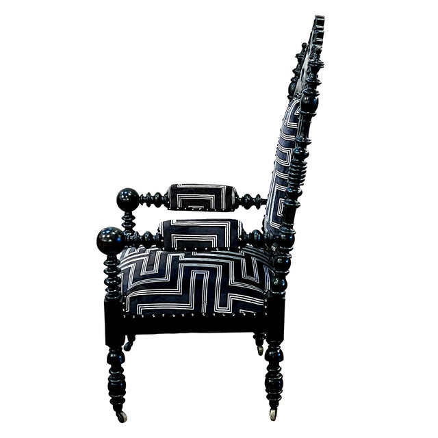 a fantastic example of Gothic revival furniture, the robust pair of ebonized Gothic style arm chairs with padded back with...