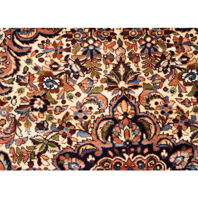Hand made antique Persian Sarouk rug in beige wool. The rug is from the beginning of 20th century in original good...