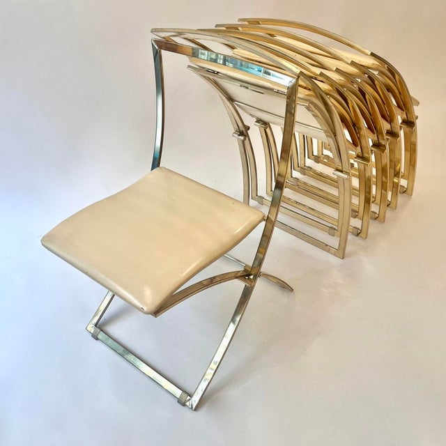 Set of six Luisa folding chairs by Marcello Cuneo, produced by Mobel Italia around 1970. Brass frame and vanilla-colored...