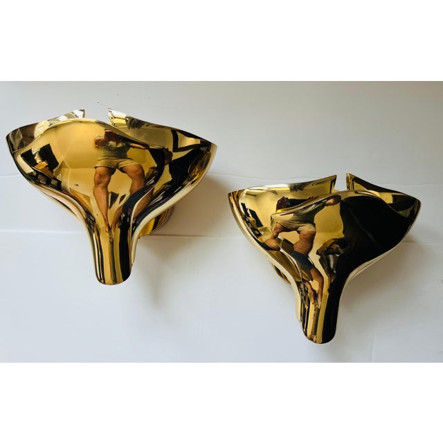 A beautiful pair of polished bronze floral wall lamps with overlapping petals. Thick heavy bronze over 10 pounds each....