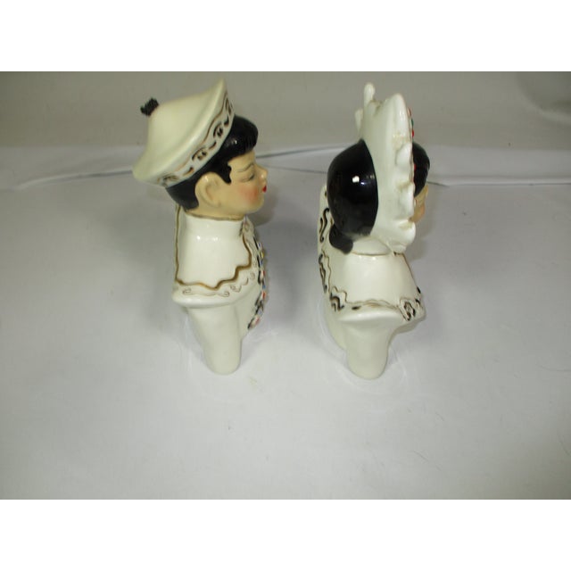 A pair of vintage ceramic Asian style shoulder bust. Made by Florence Ceramics in Pasadena California. They represent...
