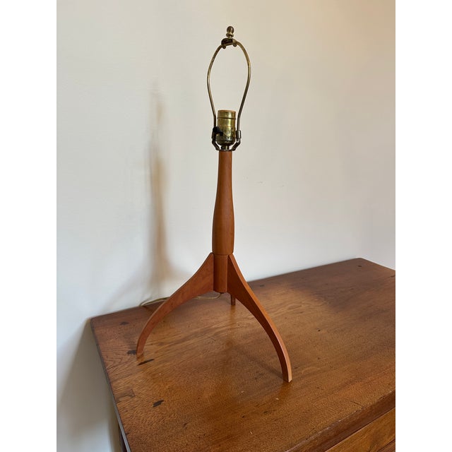 Shaker Workshop table lamps with distinctive cherry wood tripod form and fabric shades. Stamped under the stem.