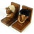 A pair of decorative teak bookends, "The Optimist and the Pessimist," designed by Hans Bolling, originated in Denmark in...