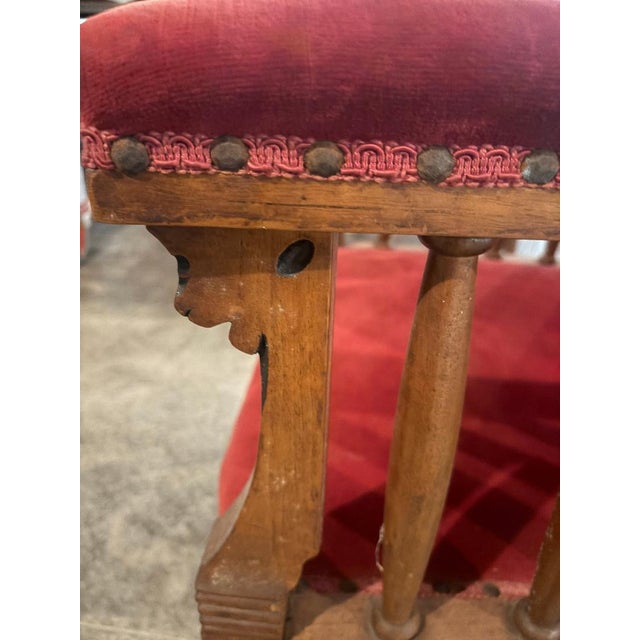 A pair of Antique red velvet and wood chairs with circular painting on each crest. These chairs are extremely well made...