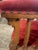 A pair of Antique red velvet and wood chairs with circular painting on each crest. These chairs are extremely well made...