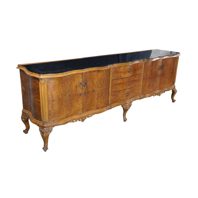 A large and impressive 8.5 foot Italian Baroque Venetian sideboard, circa 1920s. Features a serpentine form with black...