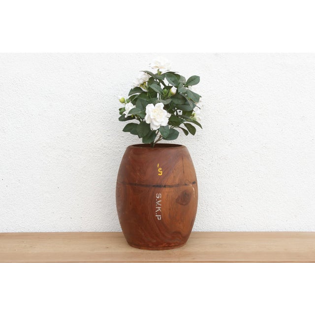 This large antique wooden pot is a relic of the old trade routes. Before digital scales, village merchants used solid...