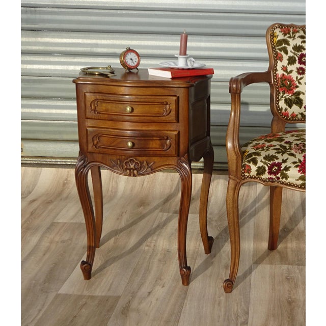 Small bedside table in solid walnut in the Louis XV style. The front and sides are curved. The top has semi-rounded edges...