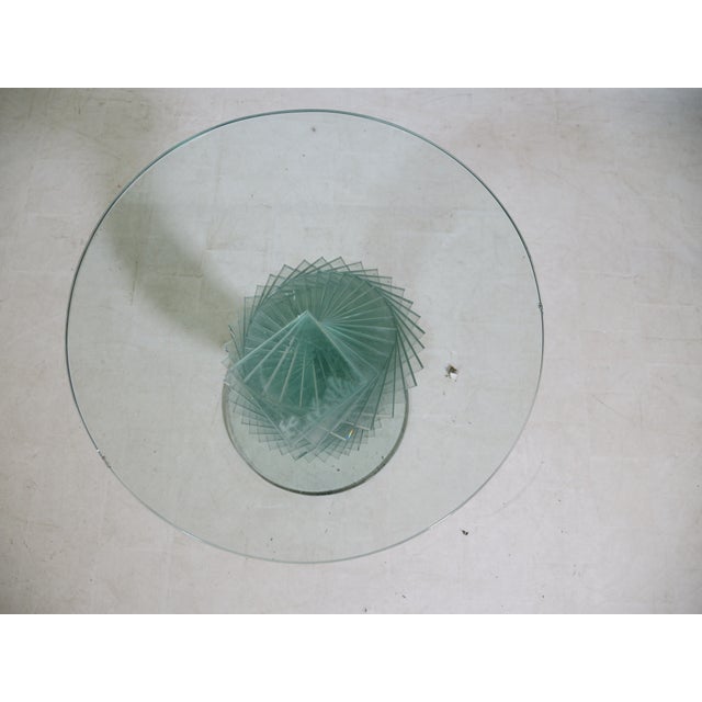 Glass side table with a sculptural helix construction made of stacked, polished glass panels. Round tabletop and base,...