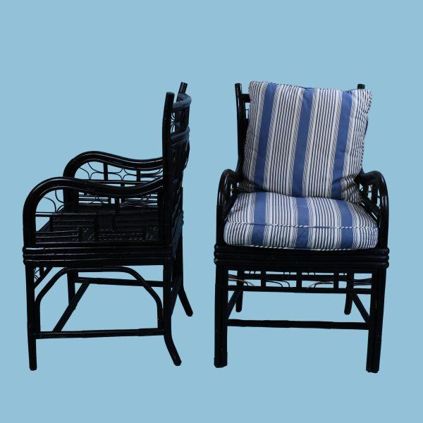A pair of Brighton-style chairs in dramatic black bamboo with Chinese Chippendale fretwork. One wears its as-found blue-...
