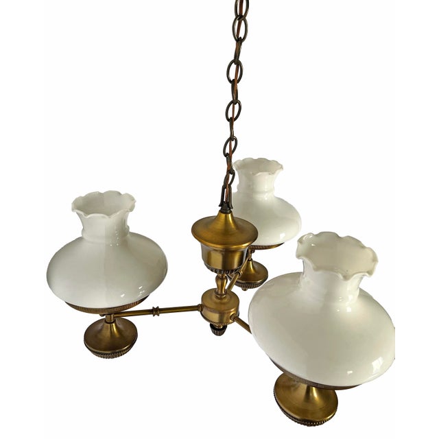 Beautiful vintage brass 3 light chandelier with milk glass globes. Original fixture in a home that was built in the...