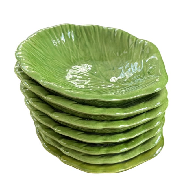 A vibrant set of seven vintage green cabbageware bowls, richly glazed and molded with naturalistic leaf veining—an iconic...