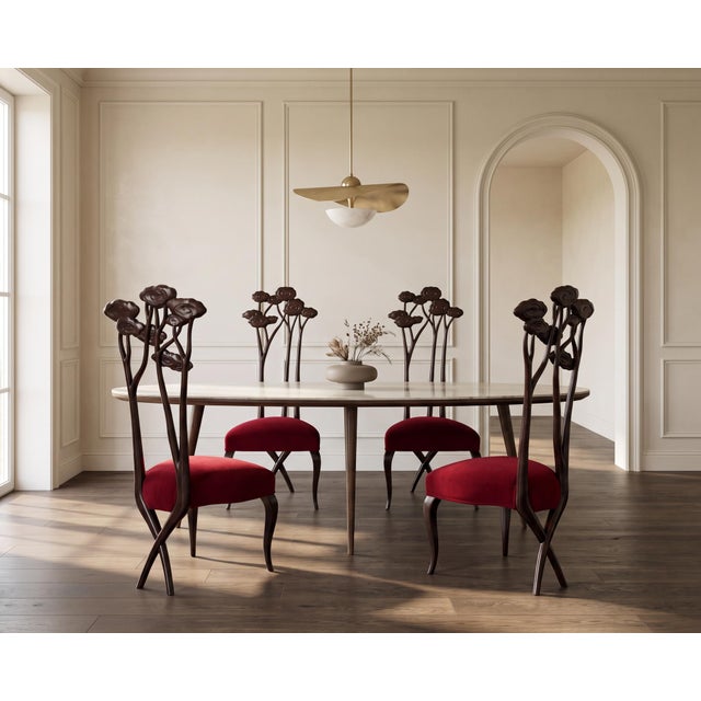 A striking set of four Christopher Guy Le Jardin dining chairs, each distinguished by a sculptural lower back of carved...