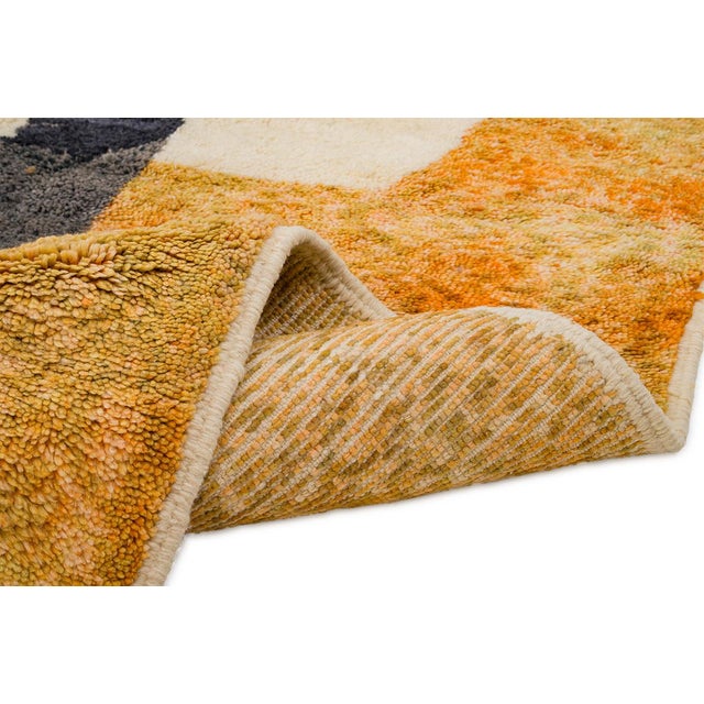 Bold, angular forms in saffron orange and charcoal black rise across a warm ivory field — abstract, sculptural, and full...