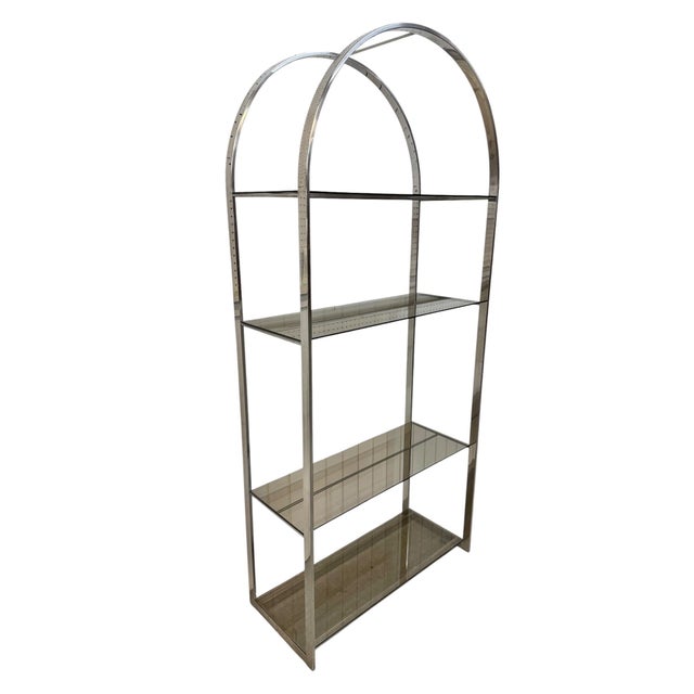 Elevate your space with this striking pair of vintage Milo Baughman flat bar chrome shelving units, crafted in the iconic...