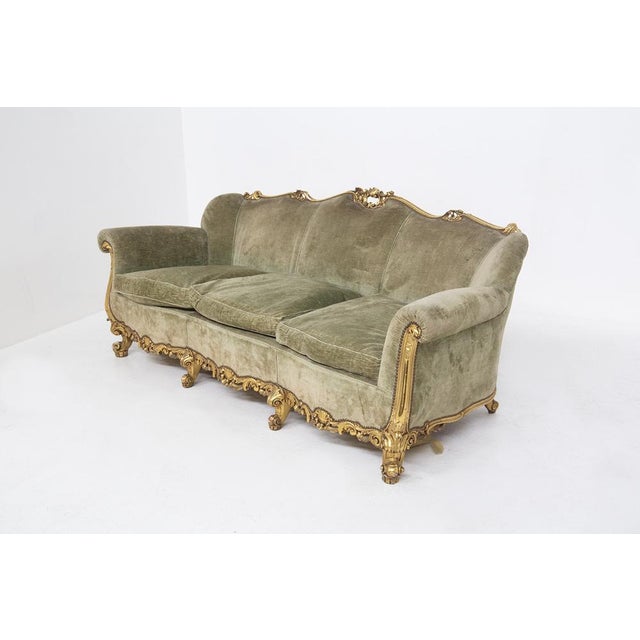 The vintage sofa is in Louis XVI style and it is of fine Italian manufacture from the early 1900s. The large sofa has...