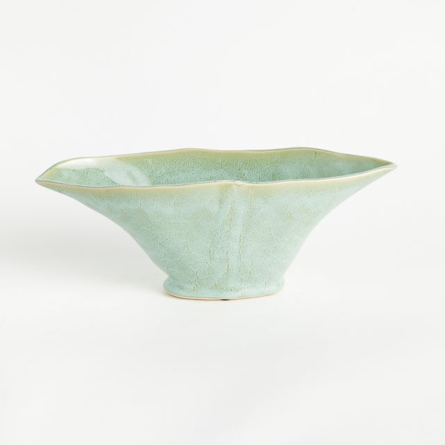 With a sculptural form and slim profile, this vase is made for narrow console or mantle. Drape a faux stem or two along...