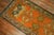 An early 20th century antique Oushak runner featuring a pumpkin orange field, forest green border with an all-over design...