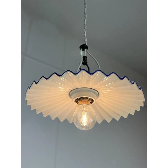 Ceramic and brass suspension lamp by Aldo Bernardi, Italy, 90s Plissetto model, mounts a lamp and 27. This piece has an...