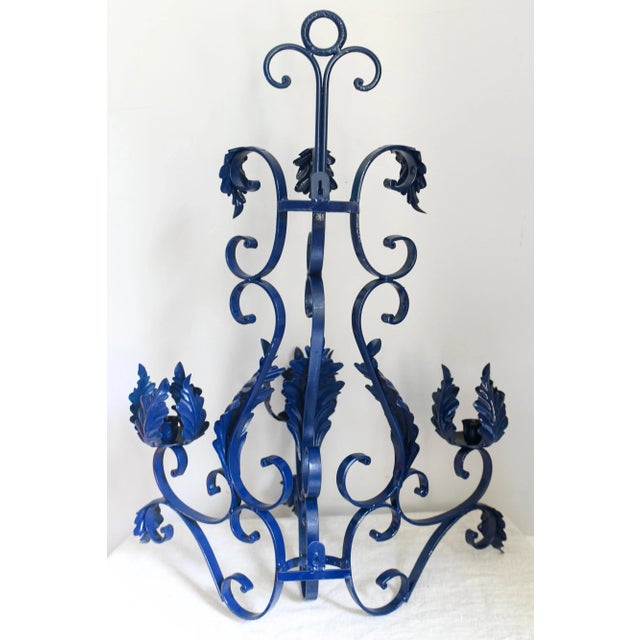 Lovely iron outdoor candelabra or wall sconce (there are two places on the back to nail or screw into a wall) with scroll...