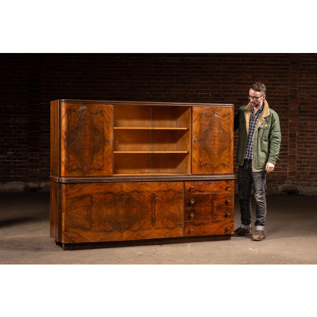 Two-piece Italian hutch cabinet veneered in dramatically-figured rosewood burl with contrasting birdseye maple interiors,...