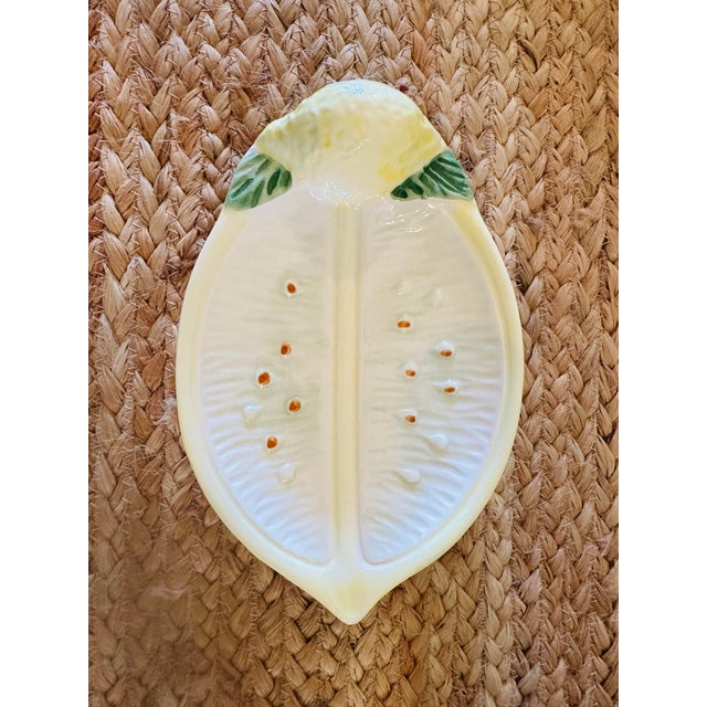 This is a vintage Italian majolica-style ceramic lemon dish or serving piece . It is molded in the shape of a halved...