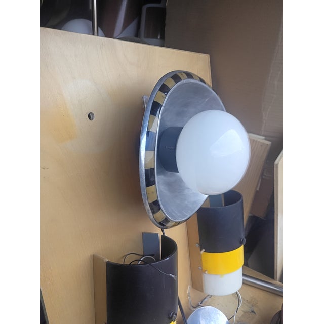 This custom made wall light is made of a aluminum polished oval plate with black and yellow. coral squares running along...