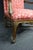 French Louis XV-style open armchair featuring a carved wood frame with graceful cabriole legs and decorative apron...