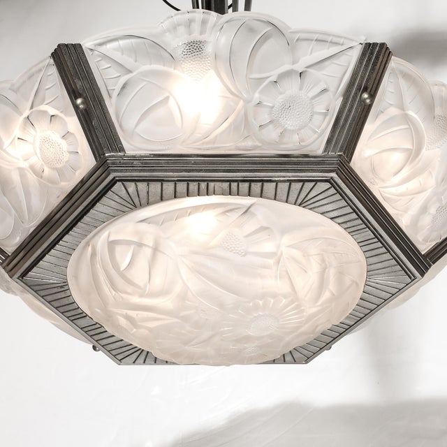 An exceptional pair of Art Deco chandeliers designed and signed by Degué, crafted in France circa 1935, embodying the...