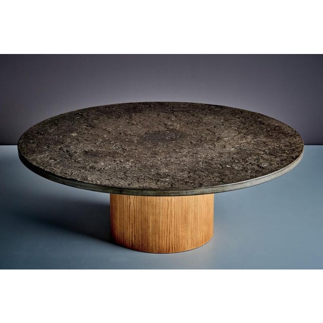 Striking 1970s coffee table featuring a solid slate top resting on a cylindrical drum-shaped plywood base. The combination...