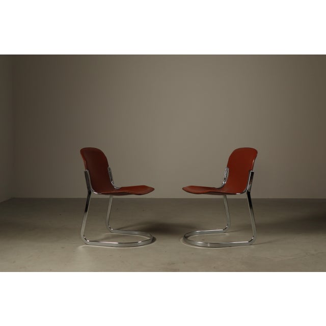 Elegant set of six Italian cantilever dining chairs by Cidue in the 1970s. The chairs feature a striking chromed steel...