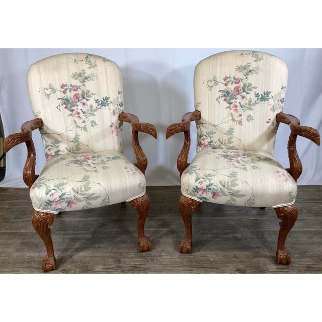 An exceptional, highly detailed pair of mid-20th-century Georgian-style open armchair lounges manufactured by the renowned...