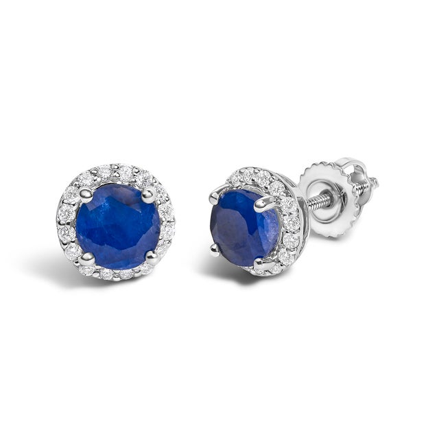 Immerse yourself in the allure of these exquisite 10K white gold stud earrings, each centered with a captivating 5mm...