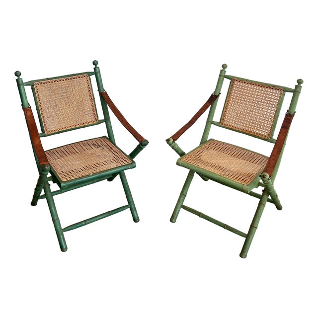 Pair of 1970s folding safari chairs in weathered faux bamboo with caned backs and seats For Sale